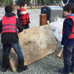 Photo by Megan Pacer/Peninsula Clarion Students from Soldotna Elementary, add a large board of wood to a pile of trash during this year's Kenai River Spring Cleanup event on Friday, May 6, 2016 at Soldotna Creek Park in Soldotna, Alaska. More than 600 kids combed the riverbanks in several locations on the central Kenai Peninsula, competing for prizes and learning about good stewardship.