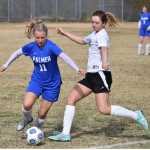 Photo by Joey Klecka/Peninsula Clarion Palmer's Haley Hanson (left) looks to possess the ball before Nikiski's Verity Feltman boots it Friday at Nikiski High School.