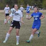 Photo by Joey Klecka/Peninsula Clarion Nikiski's Rylee Jackson eyes the airborne ball with Palmer's Anahelena Taylor (10) closing in Friday at Nikiski High School.
