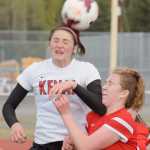 Photo by Jeff Helminiak/Peninsula Clarion Kenai Central's Lara Creighton wins a header against Wasilla's Victoria Malak on Friday at Kenai Central High School. The Warriors won 3-2.