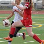 Photo by Jeff Helminiak/Peninsula Clarion Kenai Central's Kylie Morse shoulders Wasilla's Alia Donley off the ball Friday at Kenai Central High School. The Warriors won 3-2.