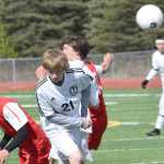 Photo by Jeff Helminiak/Peninsula Clarion Sandwiched between Wasilla's Tim Voloshin (8) and Kevin Harper (10), Kenai Central's Riley McKee gets a head on the ball Friday at Kenai Central High School.