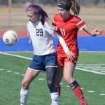 Photo by Joey Klecka/Peninsula Clarion Soldotna's Abi Tuttle (29) shields Wasilla's Hayley Brandon from the ball Saturday at Justin Maile Field in Soldotna.