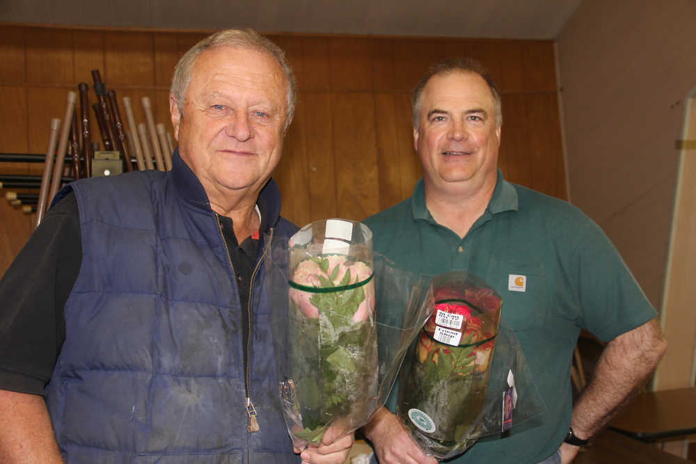 Rotarian John Davis and Rose Sale organizer Doug Schoessler.