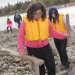Redoubt students walk the banks of the Kenai River picking up large and small trash.