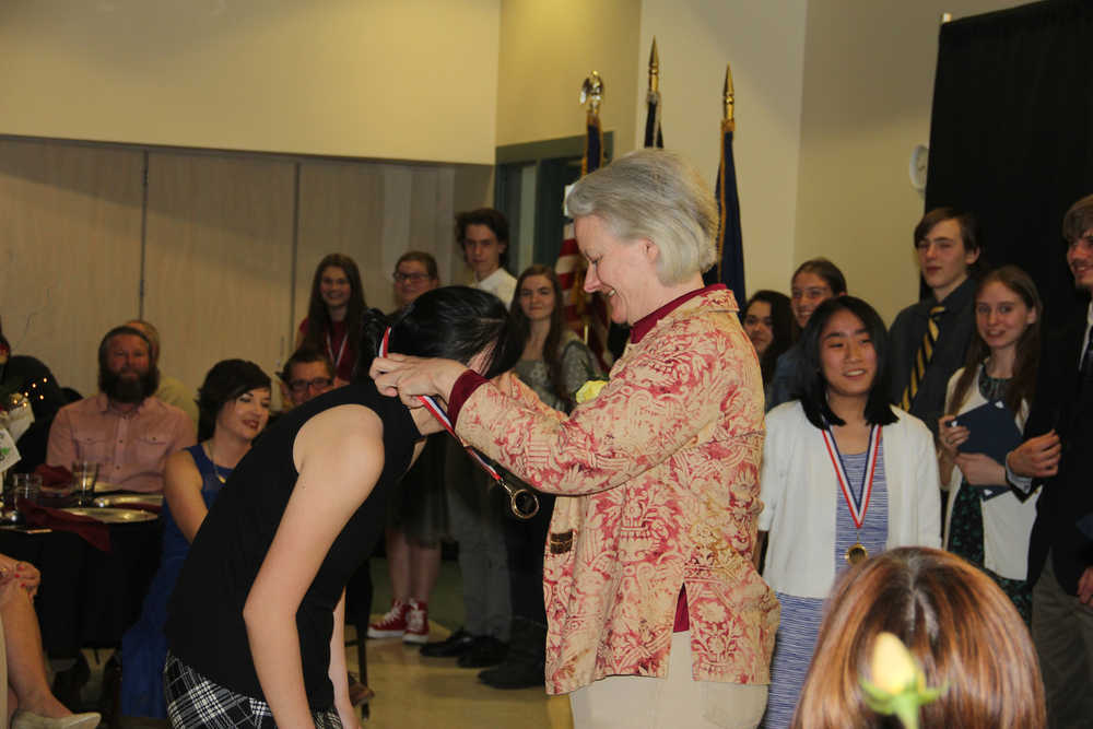 Dr. Thorsen places a CFK gold medal on this year's 1st place winners.