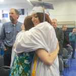 Photo by Megan Pacer/Peninsula Clarion Richele McGahan stops to hug her mother while walking into her graduation ceremony Sunday, May 8, 2016 at Cook Inlet Academy in Soldotna, Alaska. The school had a smaller graduating class than usual, with only four high school seniors.