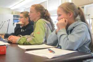 Photo by Megan Pacer/Peninsula Clarion From left: Melita Efta, 12, Bailey Epperheimer, 13, and Shelbie Naylor, 12, take in new information during a team practice session Monday, May 10, 2016 at Aurora Borealis Charter School in Kenai, Alaska. The girls and their fourth teammate will travel with an older group from Kenai Central High School to compete in the Future Problem Solving Program 2016 International Conference in Michigan in June.
