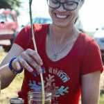 Tamara Leach uses a stripped birch branch to stir a mixture of birch, willow, and cottonwood leaves in oil during the Kenai Peninsula Garden Club's edible and medicial plants workshop on Saturday, May 14 in Soldotna. Instructor Brenda Beck said the mixture creates an ointment that can be used against muscle pain.