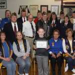 Navy recruiter Benjamin Clark presents Haedyn with an autographed 100th Anniversary VFW book.