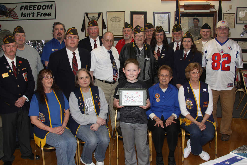 Navy recruiter Benjamin Clark presents Haedyn with an autographed 100th Anniversary VFW book.