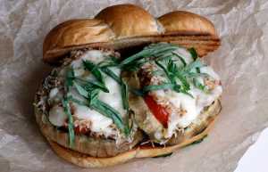 This April 2016 photo shows grilled eggplant parmigiana in Concord, N.H.  This dish, a staple of Italian cuisine, is a wonderful candidate for the grill, cooking up quickly and cleanly. And grilling this dish not only requires less oil than the traditional recipe, it ends up imparting a smokiness it could never claim before. (AP Photo/J.M. Hirsch)