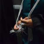 Photo by Megan Pacer/Peninsula Clarion River City Academy senior Marissa Jackson, 18, fidgets with her silver cords moments before walking into her graduation ceremony Tuesday, May 17, 2016 at the Soldotna Regional Sports Complex in Soldotna, Alaska. She joined eight of her peers in an intimate ceremony filled with inside jokes and tearful thank you's.