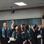 Photo by Megan Pacer/Peninsula Clarion This year's nine graduates of River City Academy toss their caps into the air after getting their diplomas during a graduation ceremony Tuesday, May 17, 2016 at the Soldotna Regional Sports Complex in Soldotna, Alaska.