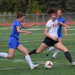 Photo by Joey Klecka/Peninsula Clarion Kenai Central junior Lara Creighton (right) dribbles the ball against Palmer's Elliese Wright in a Northern Lights Conference tournament quarterfinal Thursday afternoon at Ed Hollier Field in Kenai.