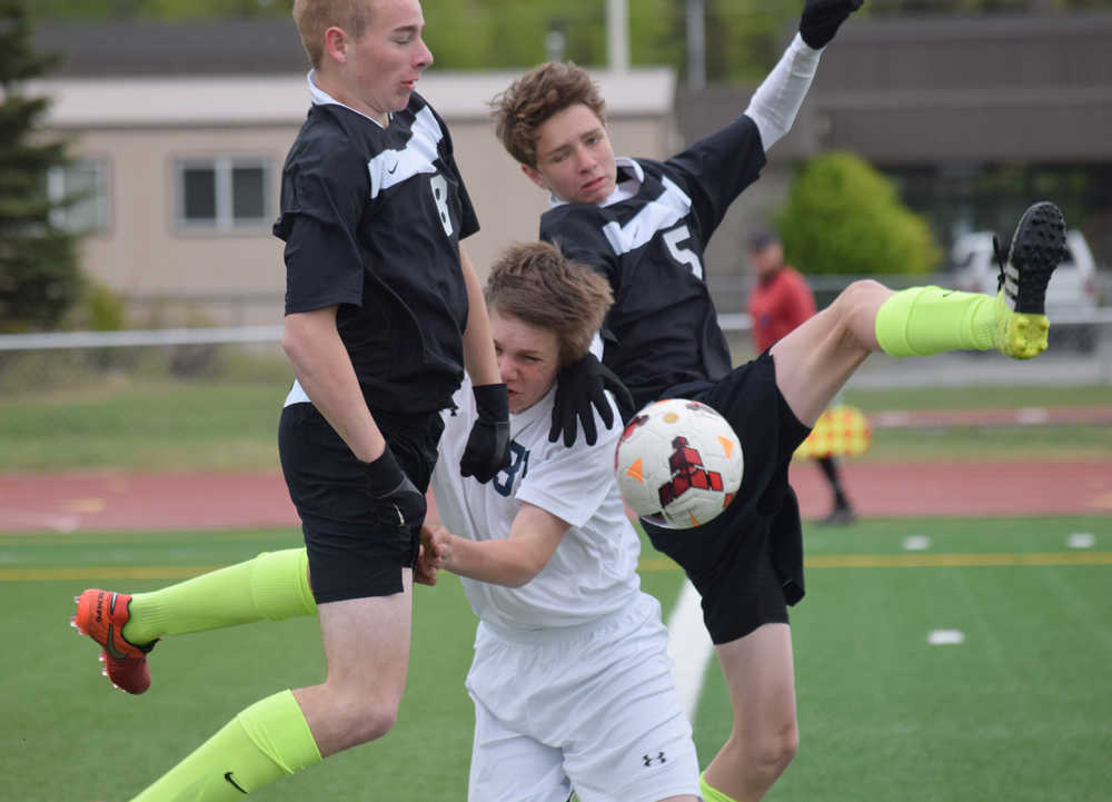 Photo by Joey Klecka/Peninsula Clarion Colony's Cade Johnstone (8) and Michael Sliwa (5) collide in the goal box with Soldotna's Eli Sheridan, Friday at Ed Hollier Field in Kenai.