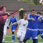 Photo by Joey Klecka/Peninsula Clarion Kodiak goalkeeper Matt Schauff pokes away the ball with Kenai Central forward Braydon Goodman (10) pressuring Friday at Ed Hollier Field in Kenai.