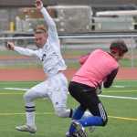 Photo by Joey Klecka/Peninsula Clarion Soldotna midfielder Rykker Riddall nearly collides with Kodiak goalkeeper Matt Schauff, Friday at Ed Hollier Field in Kenai.