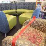 Photo by Megan Pacer/Peninsula Clarion Red tape prevents people from sitting on several pieces of vandalized furniture Wednesday, May 25, 2016 at the Kenai Community Library in Kenai, Alaska. Several chairs and a stool were destroyed with a paint-like substance, and a couch was slashed with a knife at the library last week.