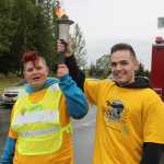 Torch keeps burning during run in the rain for Special Olympics