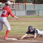 Photo by Jeff Helminiak/Peninsula Clarion Soldotna's Kenny Griffin dives back to first base ahead of the tag of Ben Werner on Friday in the Southcentral Conference championship at Coral Seymour Memorial Park in Kenai.