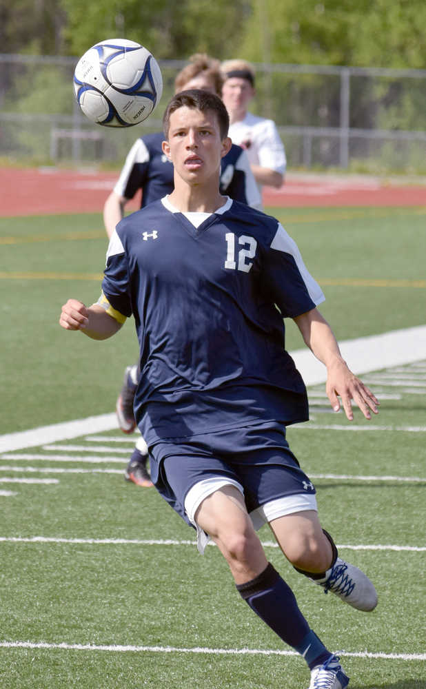 Photo by Joey Klecka/Peninsula Clarion Soldotna senior Dylan Kuntz keeps an eye on the ball Friday afternoon at Eagle River High School in a state soccer semifinal against Juneau-Douglas.
