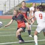 Photo by Joey Klecka/Peninsula Clarion Kenai Central freshman Hayley Maw (center) chases the ball against Juneau-Douglas Friday afternoon at Eagle River High School.