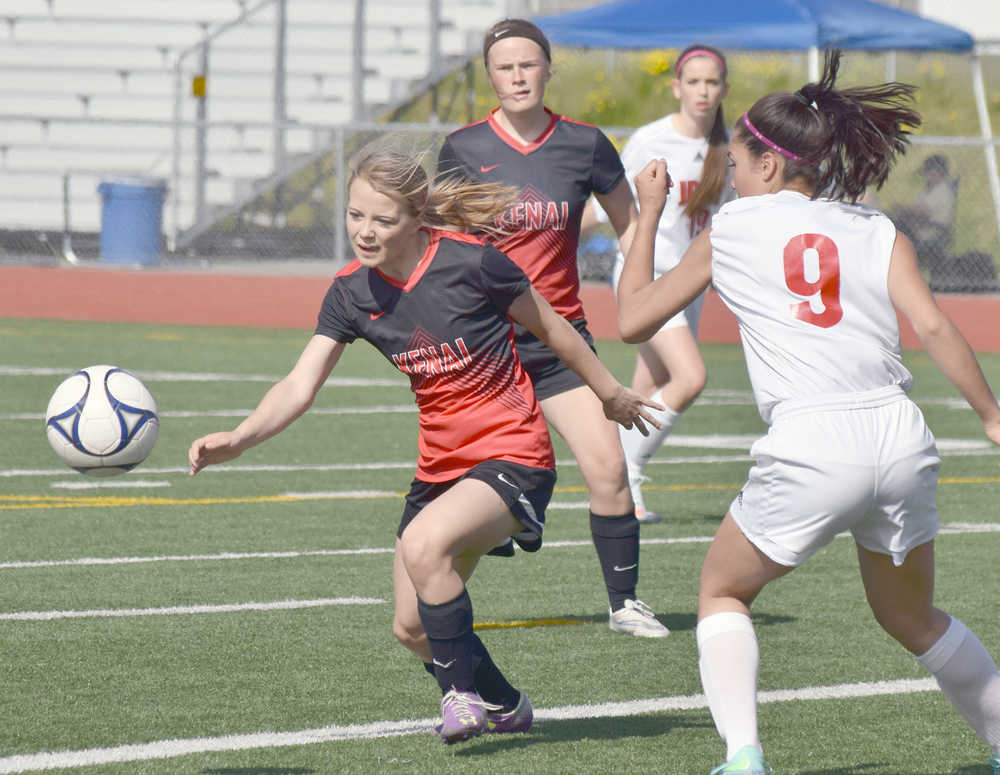 Photo by Joey Klecka/Peninsula Clarion Kenai Central freshman Hayley Maw (center) chases the ball against Juneau-Douglas Friday afternoon at Eagle River High School.