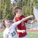 Photo by Joey Klecka/Peninsula Clarion Kenai Central freshman Damien Redder (13) heads the ball with Service sophomore Dorian Cornichuck in Friday's state soccer semifinal contest at Service High School.