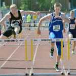 Photo by Joey Klecka/Peninsula Clarion Cook Inlet Academy junior Noah Leaf (218) eyes the final hurdle of the 1-2-3A boys 300-meter hurdles Saturday with race winner Caleb Velez of Eielson at his side, at the state track and field championships at Dimond Alumni Field in Anchorage.