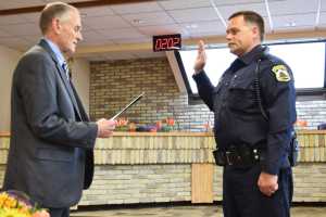 Photo by Megan Pacer/Peninsula Clarion Attendees at a swearing in ceremony for Kenai's new police chief, David Ross, enjoyed a cake made in his honor Tuesday, May 31, 2016 at Kenai City Hall in Kenai, Alaska. Ross takes over for former Kenai Police Chief Gus Sandahl, who announced his retirement from law enforcement in early May.