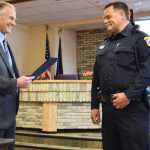 Photo by Megan Pacer/Peninsula Clarion David Ross is sworn in as Kenai's new police chief by his father, Richard Ross, on Tuesday, May 31, 2016 at Kenai City Hall in Kenai, Alaska. Richard Ross served as Kenai's police chief from 1975-1993.