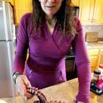 Louise Nutter prepares to slice up and marinate an octopus tentacle she previously used to make prints in her artwork on Wednesday, June 1 at her house in Nikiski. Nutter began making octopus prints after catching the creatures in her shrimp traps in Prince William Sound.