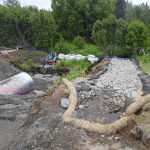 Photo by Kelly Sullivan/ Peninsula Clarion Alaska Department of Transporation employees diverted the creek contained by the aging culvert that is currently being replaced Monday, June 6, 2016, in Kenai, Alaska.