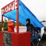 Paxton McKnight sets up his lemonade and popcorn stand near the Sushi Exchange restaurant on Saturday, June 11 in Soldotna. McKnight was one of several local children who participated in Lemonade Day, an event created by the Kenai Chamber of Commerce to promote business skills among youth.