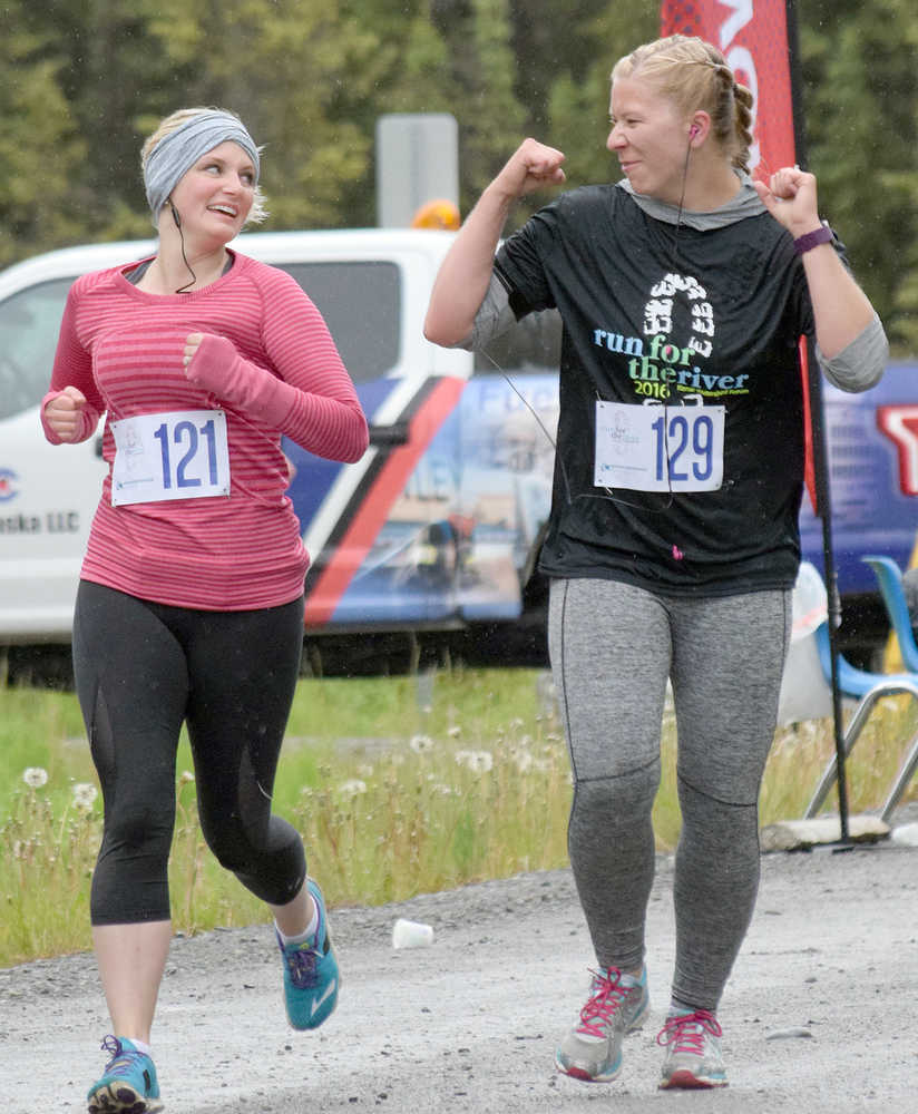 Photo by Joey Klecka/Peninsula Clarion Hope Derkevorkian (121) shares a laugh with Kimberly Glidden in Saturday's Run for the River women's 5K race in Soldotna.