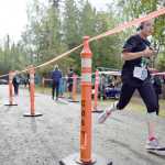 Photo by Joey Klecka/Peninsula Clarion Nadia Anders crosses the finish line of the women's 10-miler Saturday morning at the Run for the River in Soldotna.
