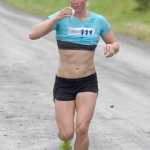 Photo by Joey Klecka/Peninsula Clarion Women's 5K race winner LeeAnn Burns of Eagle River takes a quick drink midway through Saturday's Run for the River in Soldotna.