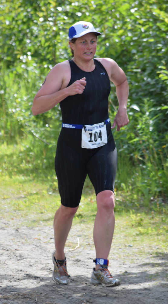 Photo by Jeff Helminiak/Peninsula Clarion Jenny Kimball of Anchorage nears the finish of the 5-kilometer run and the finish line Sunday at Tri the Kenai at Tsalteshi Trails. Kimball won the women's Sprint division.