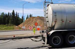 Photo by Elizabeth Earl/Peninsula Clarion A flagger redirects traffic off the Kenai Spur Highway for a construction project at approximately Mile 10.2. The Alaska Department of Transportation and Public Facilities is replacing a fish passage culvert under the highway, which could close that section until as late as July 1.