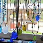The glass necklaces that Jenna Hansen, her sister Megan and her mother Hara make hang in their home studio in Nikiski, Alaska on Wednesday, June 1, 2016. Hansen and her family turn recycled glass into handmade jewelry that they sell.