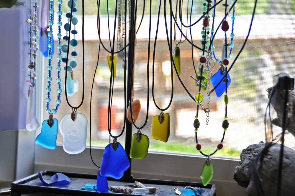 The glass necklaces that Jenna Hansen, her sister Megan and her mother Hara make hang in their home studio in Nikiski, Alaska on Wednesday, June 1, 2016. Hansen and her family turn recycled glass into handmade jewelry that they sell.