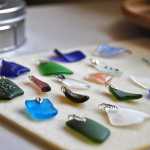 Photo by Elizabeth Earl/Peninsula Clarion The glass pendants that Jenna Hansen, her sister Megan and her mother Hara make wait to be strung onto necklaces in their home studio in Nikiski, Alaska on Wednesday, June 1, 2016. Hansen and her family turn recycled glass into handmade jewelry that they sell.