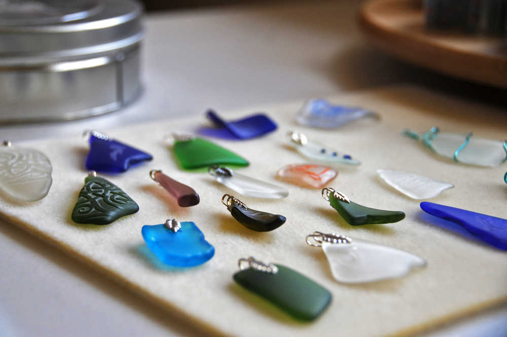 Photo by Elizabeth Earl/Peninsula Clarion The glass pendants that Jenna Hansen, her sister Megan and her mother Hara make wait to be strung onto necklaces in their home studio in Nikiski, Alaska on Wednesday, June 1, 2016. Hansen and her family turn recycled glass into handmade jewelry that they sell.