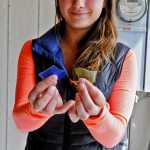 Photo by Elizabeth Earl/Peninsula Clarion Jenna Hansen shows the results of the cement mixer on recycled glass bottles at her home in Nikiski, Alaska on Wednesday, June 1, 2016. Hansen and her family turn recycled glass into handmade jewelry that they sell.