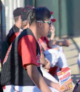 Photo by Joey Klecka/Peninsula Clarion Yi-Hsin Huang scouts out the opposition between pitching stints against the Alaska Goldpanners of Fairbanks June 14 at Coral Seymour Memorial Park in Kenai.