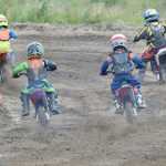 Photo by Joey Klecka/Peninsula Clarion A field of young riders take off in the 50cc Novice category Saturday at the Kenai Peninsula Racing Lions motocross track in Kenai.