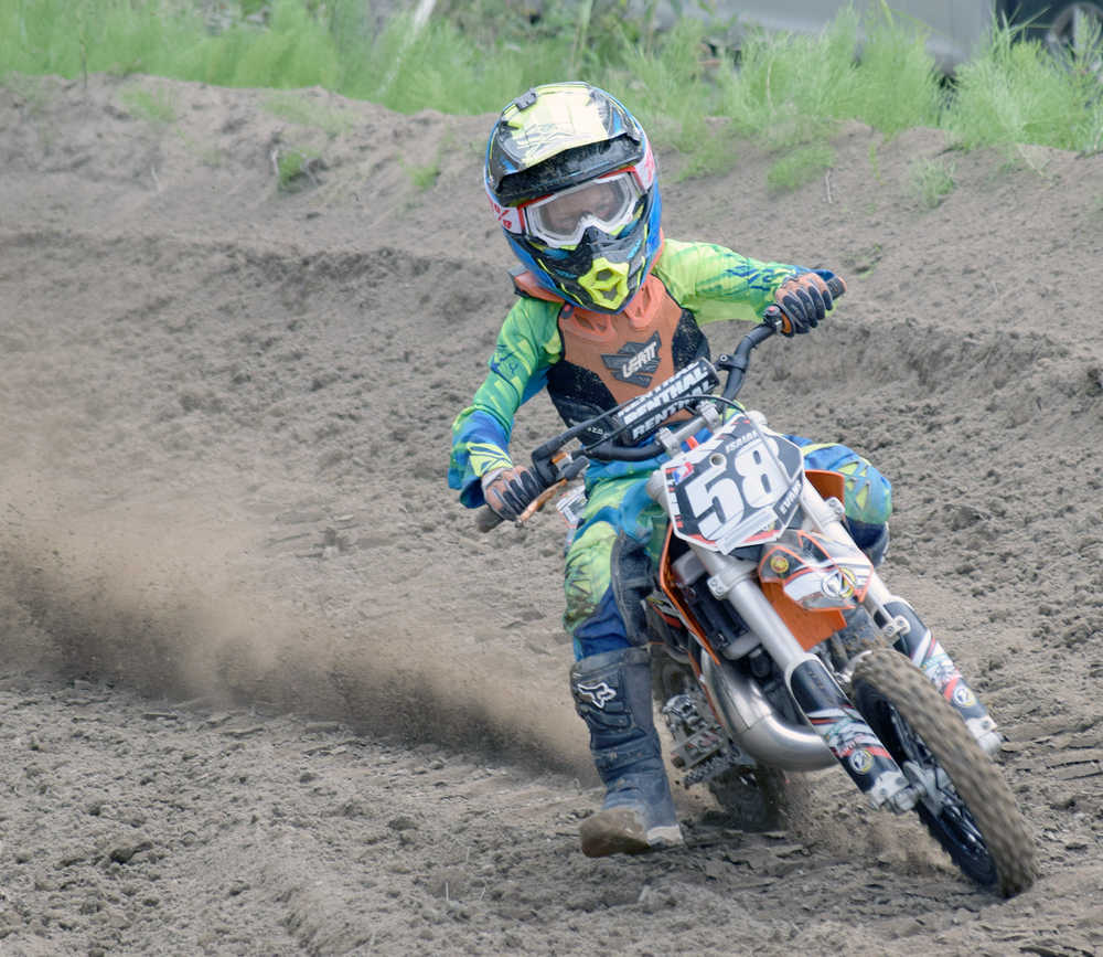 Photo by Joey Klecka/Peninsula Clarion 10-year-old Isaiah Evans rounds a turn Saturday at the Kenai Peninsula Racing Lions motocross track in Kenai.