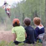 Photo by Joey Klecka/Peninsula Clarion A trio of boys watch the action up close Saturday at the Kenai Peninsula Racing Lions motocross track in Kenai.