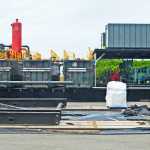 Ben Boettger/Peninsula Clarion BlueCrest's drill rig sits on the wellpad of the company's Hansen Production Facility during a ceremonial facility opening on Saturday, June 25, 2016 near Anchor Point, Alaska. A pipe from a future well can be seen poking up under the black plastic sheet in the foreground. BlueCrests expects the rig to begin drilling for oil in Cook Inlet's offshore Cosmopolitan formation in August, after the rig's 180 foot derrick tower arrives from Texas.